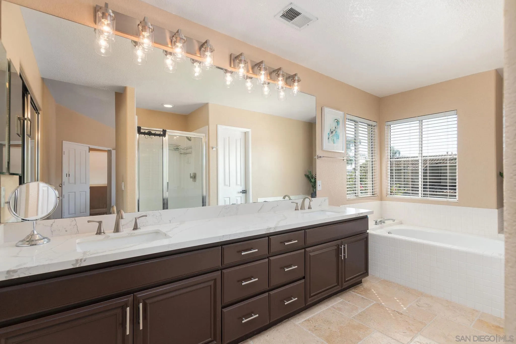 4532 Avenida Privado Oceanside, CA 92057 - Photo 21 of 40 a bathroom with a granite countertop double vanity sink a large mirror and a bathtub