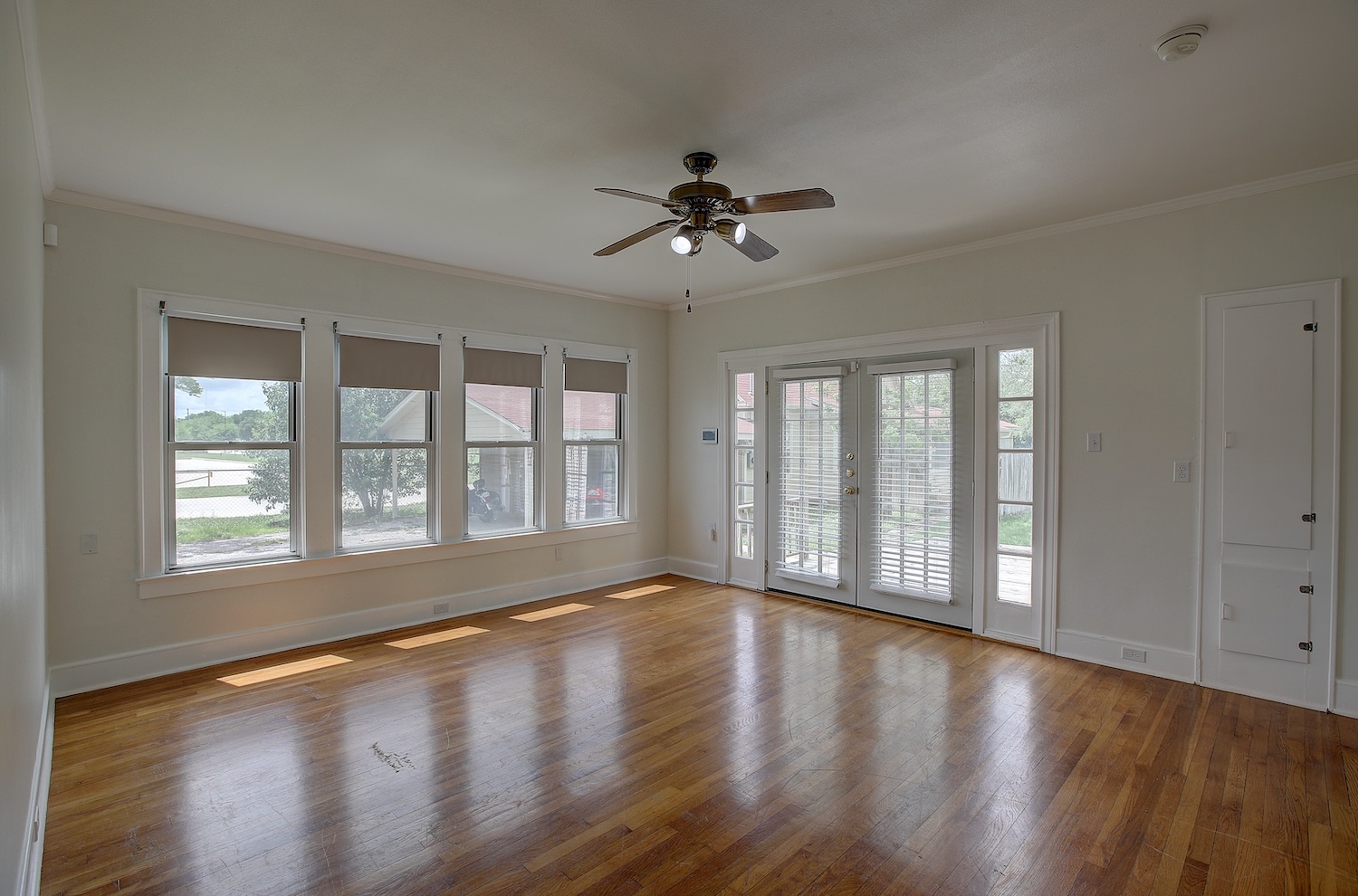 1708 Olive Street Georgetown, TX 78626 - Photo 15 of 40 a view of an empty room with wooden floor and a window