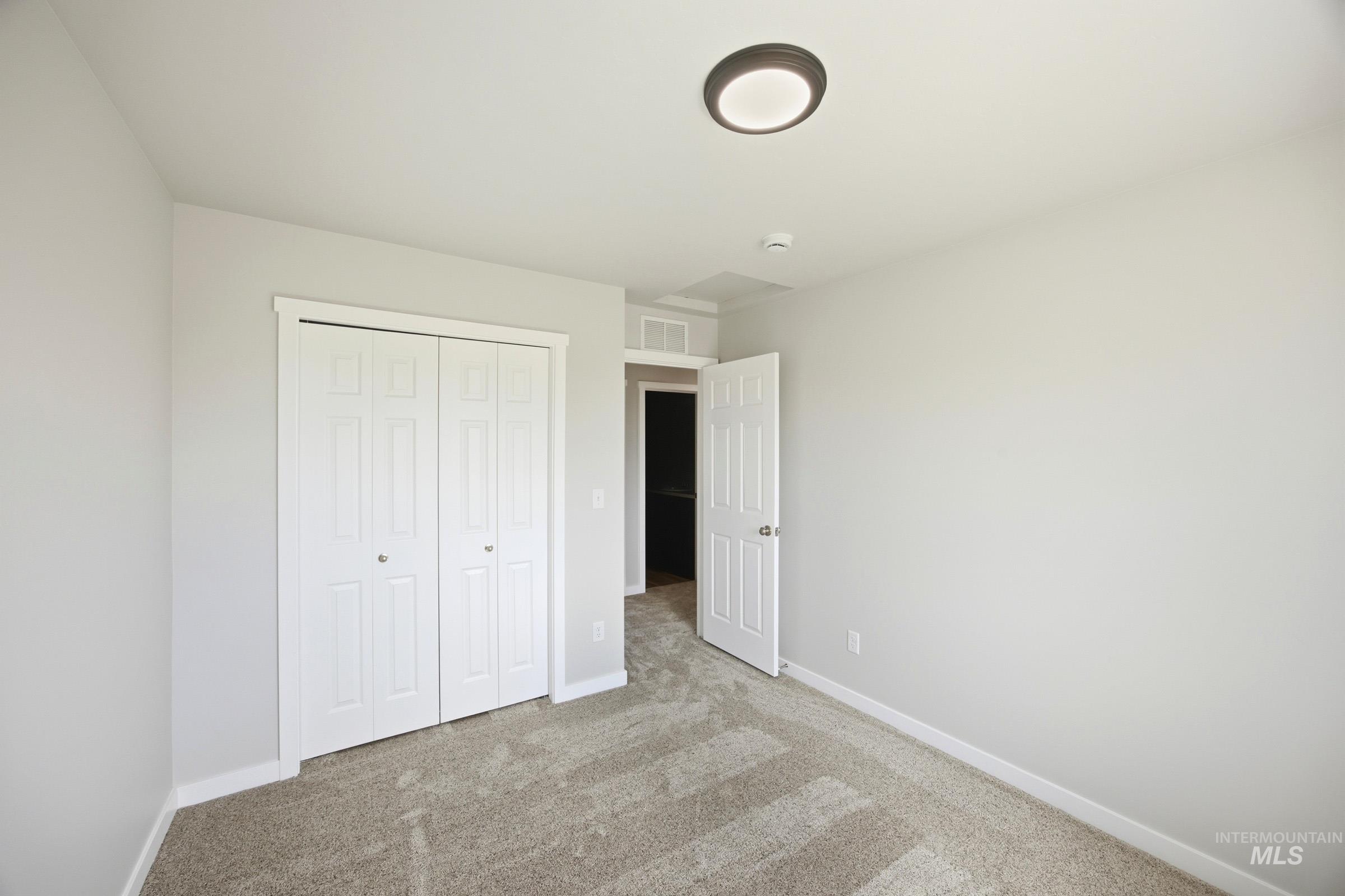14044 Shiny Spruce Street Caldwell, ID 83607 - Photo 24 of 24 Neutral gray walls with white trim and carpeting