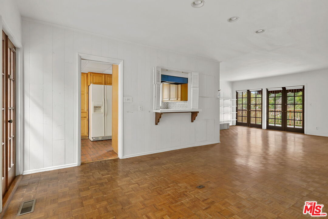 592 Dryad Road Santa Monica, CA 90402 - Photo 12 of 49 a view of an empty room with a window and wooden floor