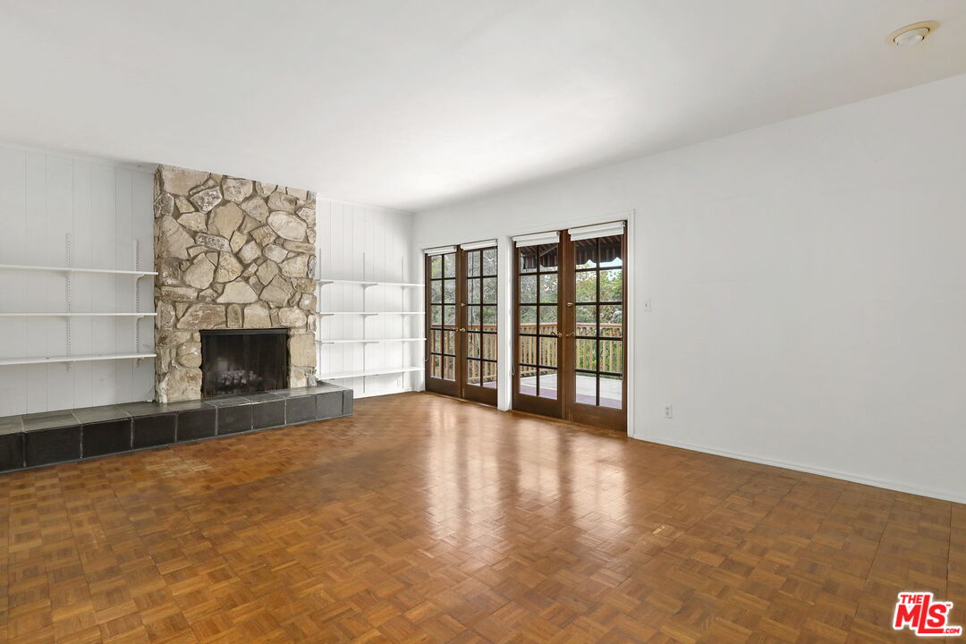 592 Dryad Road Santa Monica, CA 90402 - Photo 9 of 49 a view of an empty room with a fireplace and a window