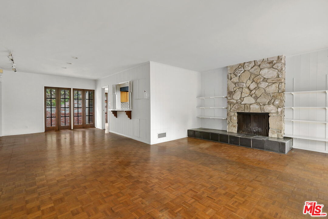 592 Dryad Road Santa Monica, CA 90402 - Photo 10 of 49 an empty room with windows and fireplace