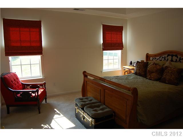 10529 Gold Pan Road Charlotte, NC 28215 - Photo 5 of 13 a bedroom with a bed and windows