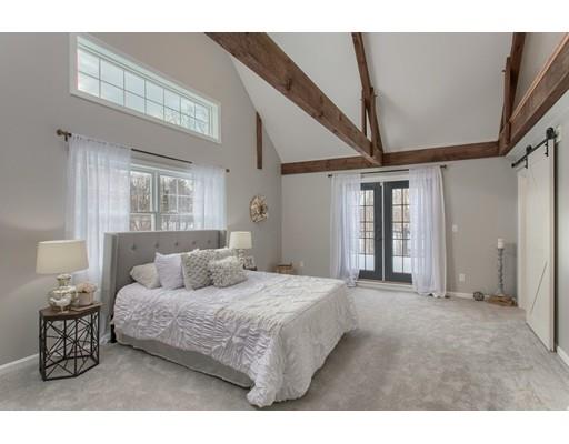 16 Longview Road Chelmsford, MA 01824 - Photo 17 of 30 a bedroom with a large bed and a chandelier