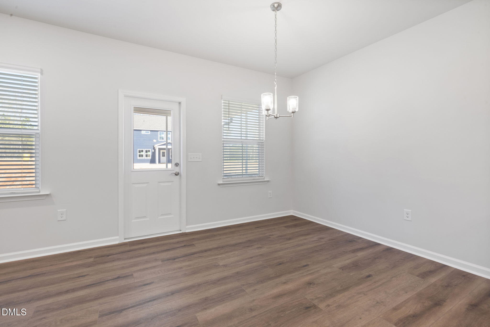 348 Broomside Avenue Raleigh, NC 27603 - Photo 10 of 33 a view of an empty room with wooden floor and a window
