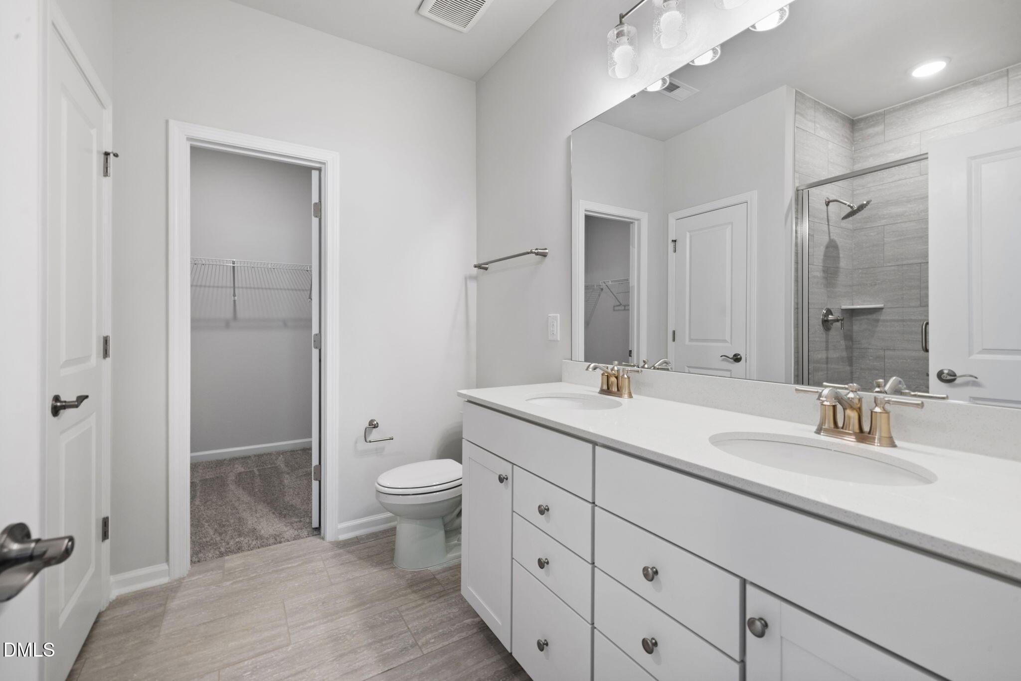 348 Broomside Avenue Raleigh, NC 27603 - Photo 15 of 33 a bathroom with a double vanity sink toilet mirror and a shower