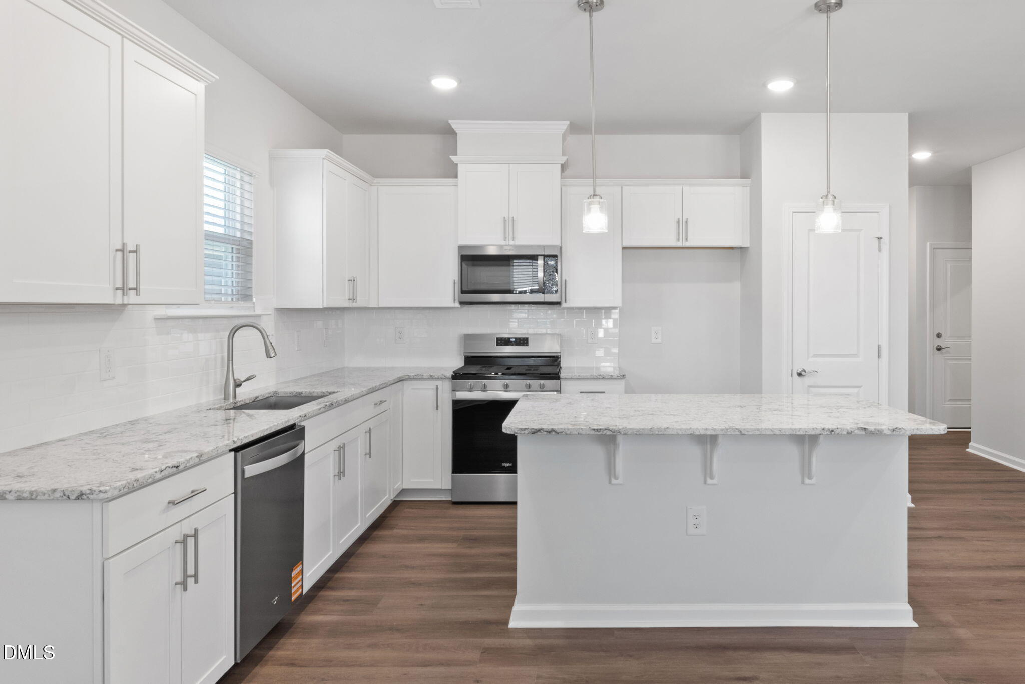 348 Broomside Avenue Raleigh, NC 27603 - Photo 5 of 33 a kitchen with stainless steel appliances granite countertop a stove a sink and white cabinets