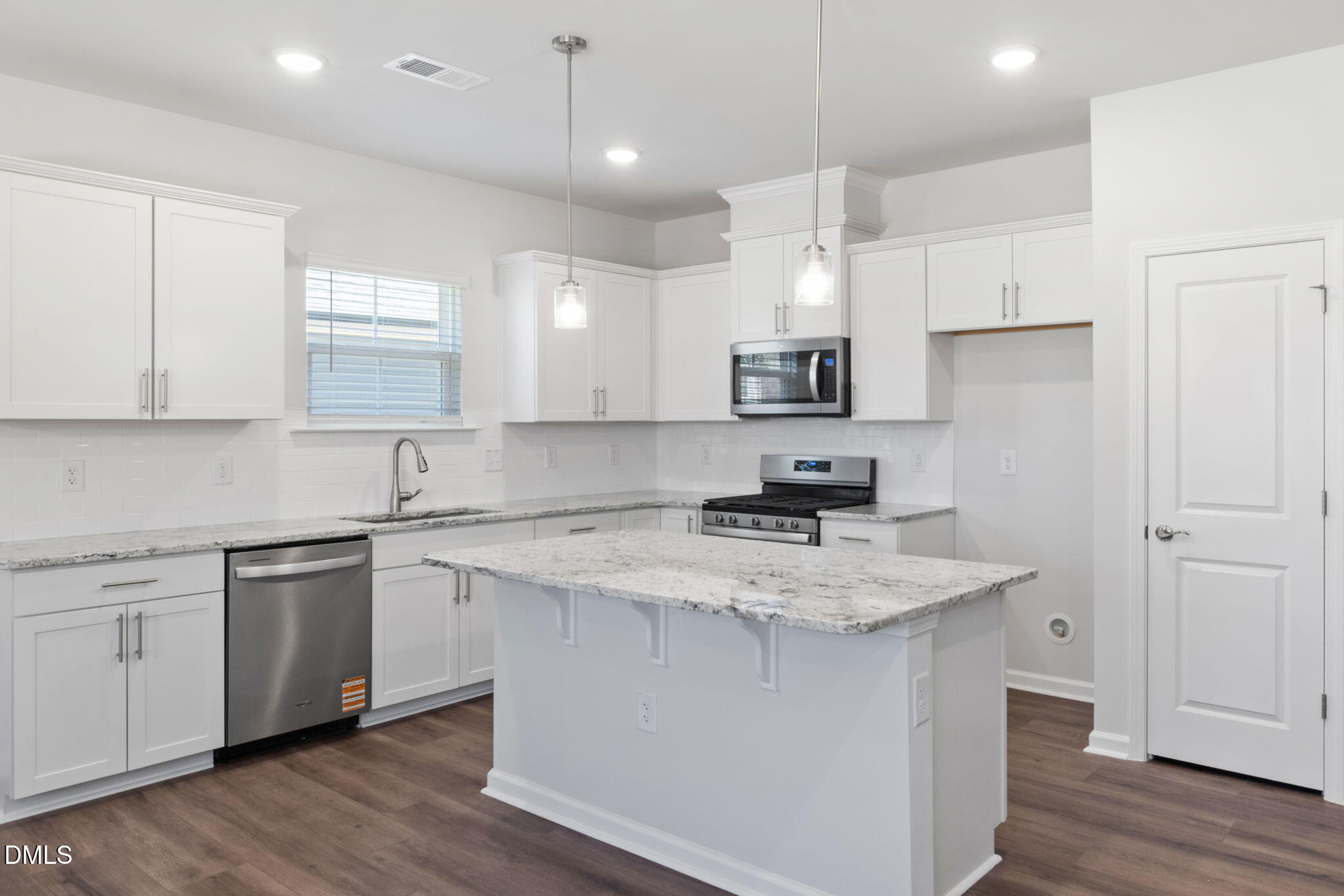 348 Broomside Avenue Raleigh, NC 27603 - Photo 8 of 33 a kitchen with a sink a stove a refrigerator and white cabinets