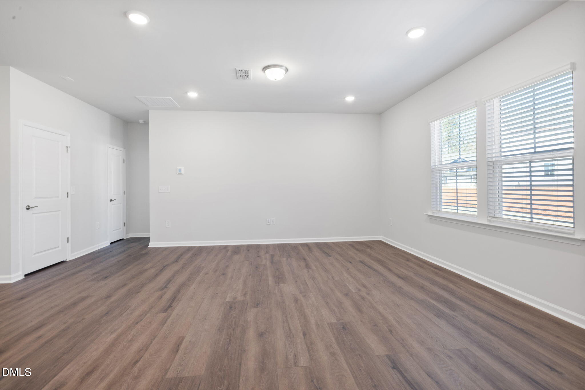 348 Broomside Avenue Raleigh, NC 27603 - Photo 9 of 33 an empty room with wooden floor and windows