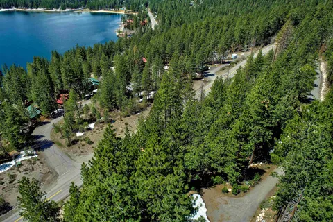 an aerial view of residential house with outdoor space and lake view