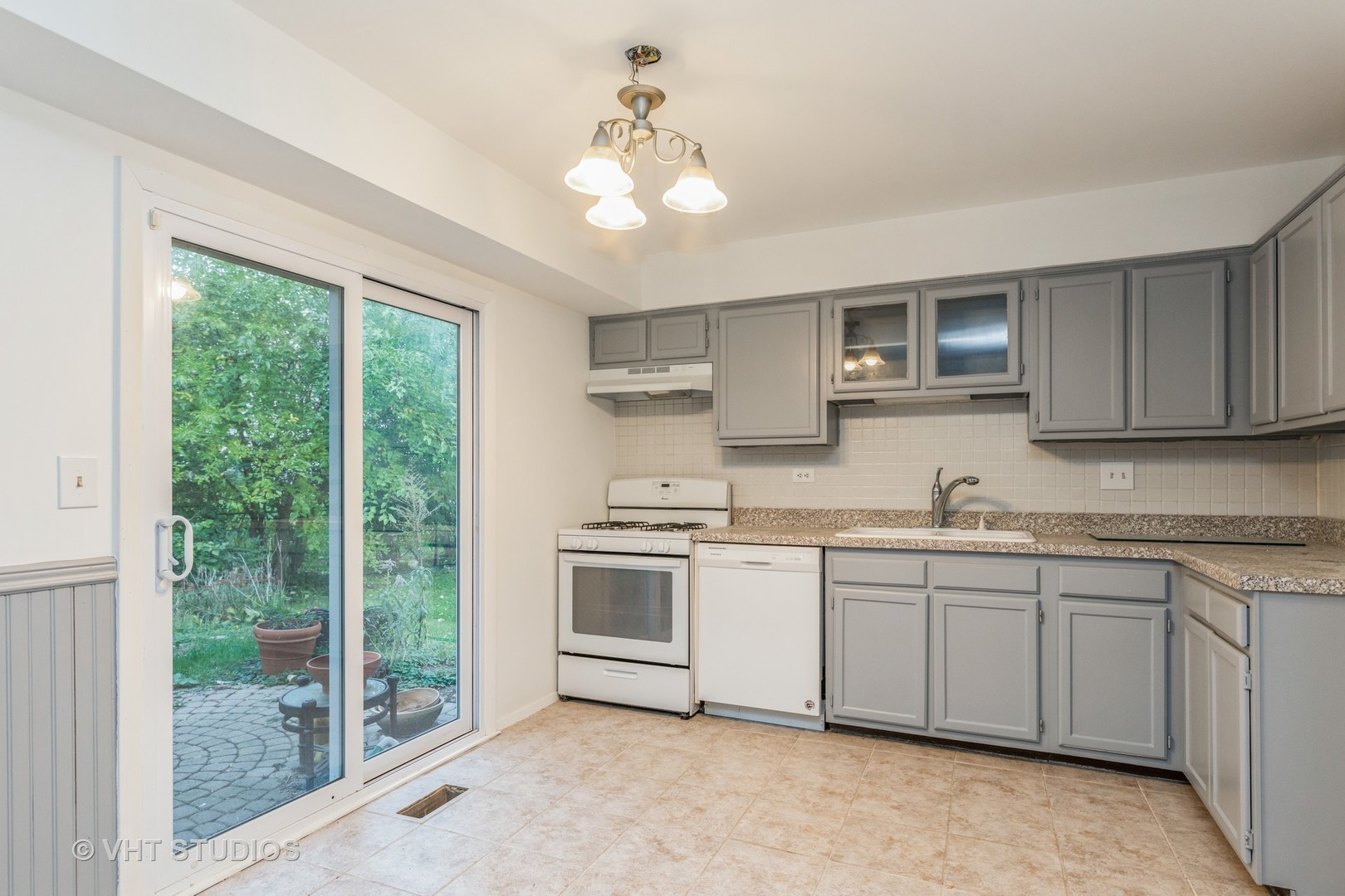1050 Perry Drive Algonquin, IL 60102 - Photo 6 of 11 a kitchen with stainless steel appliances granite countertop a stove sink and cabinets