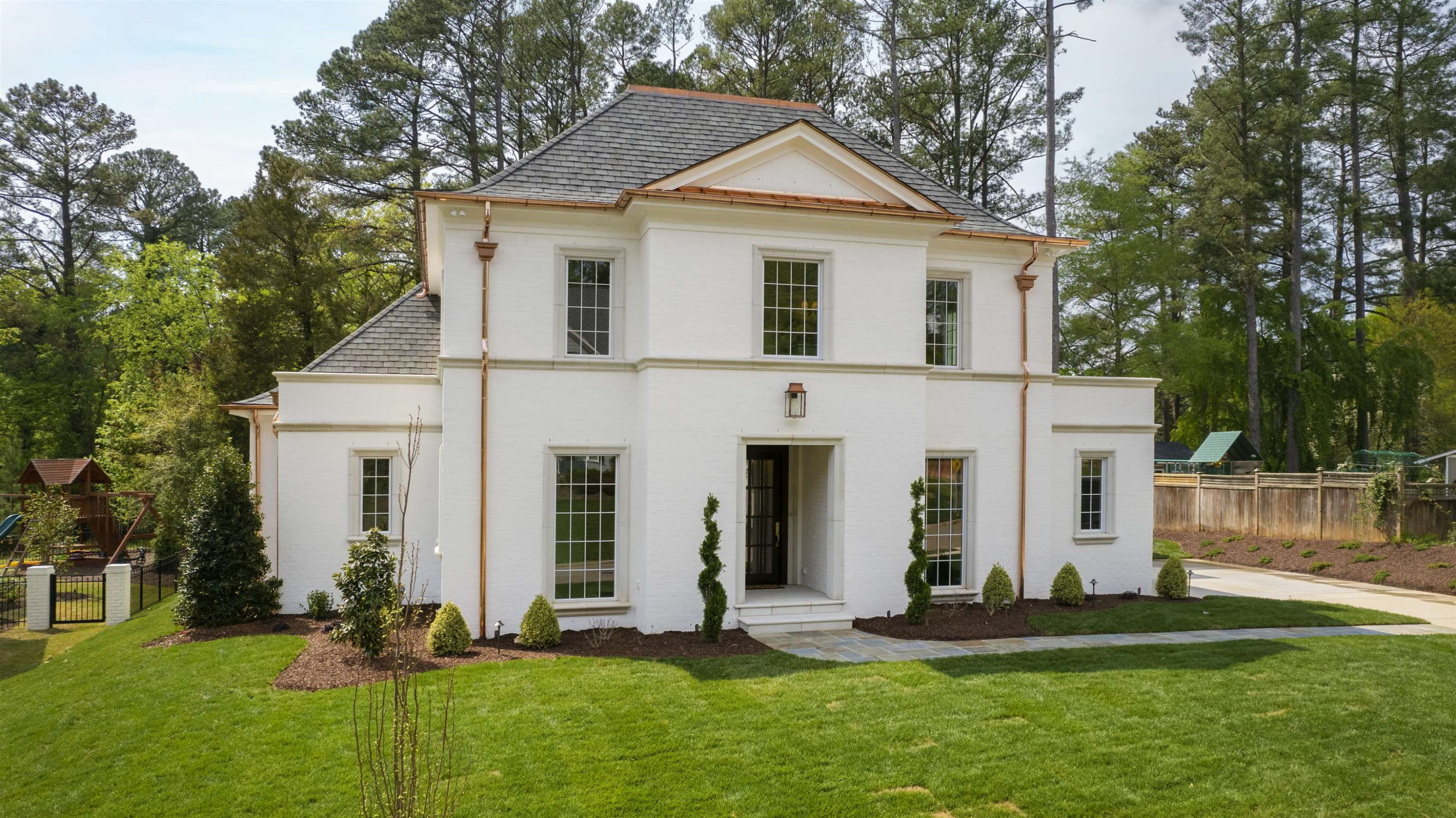 a front view of a house with a yard