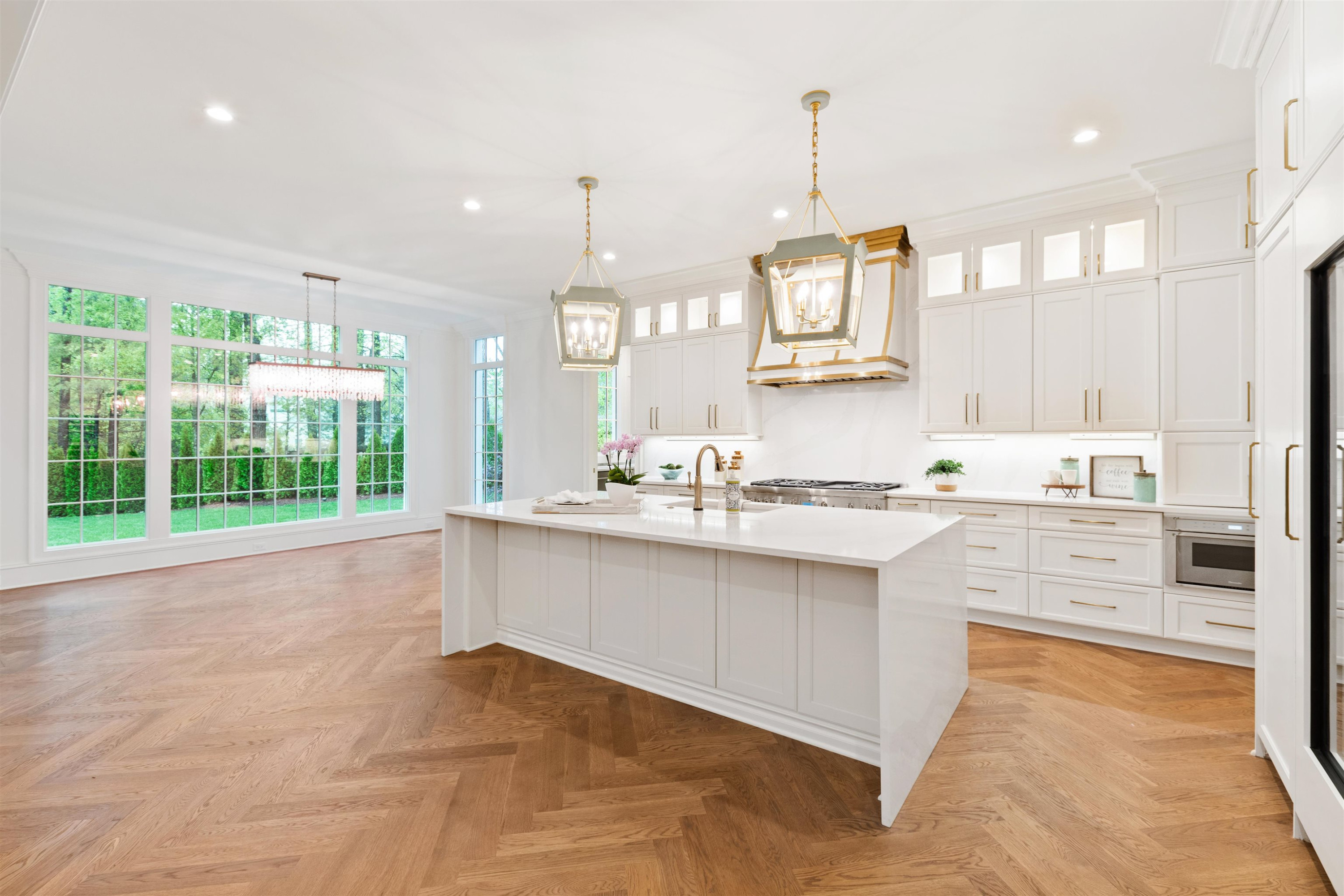4813 Rampart Street Raleigh, NC 27609 - Photo 5 of 7 a large kitchen with kitchen island a large counter top space a sink stainless steel appliances and cabinets