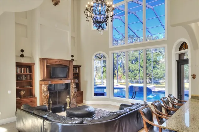 a living room with furniture kitchen and a large window