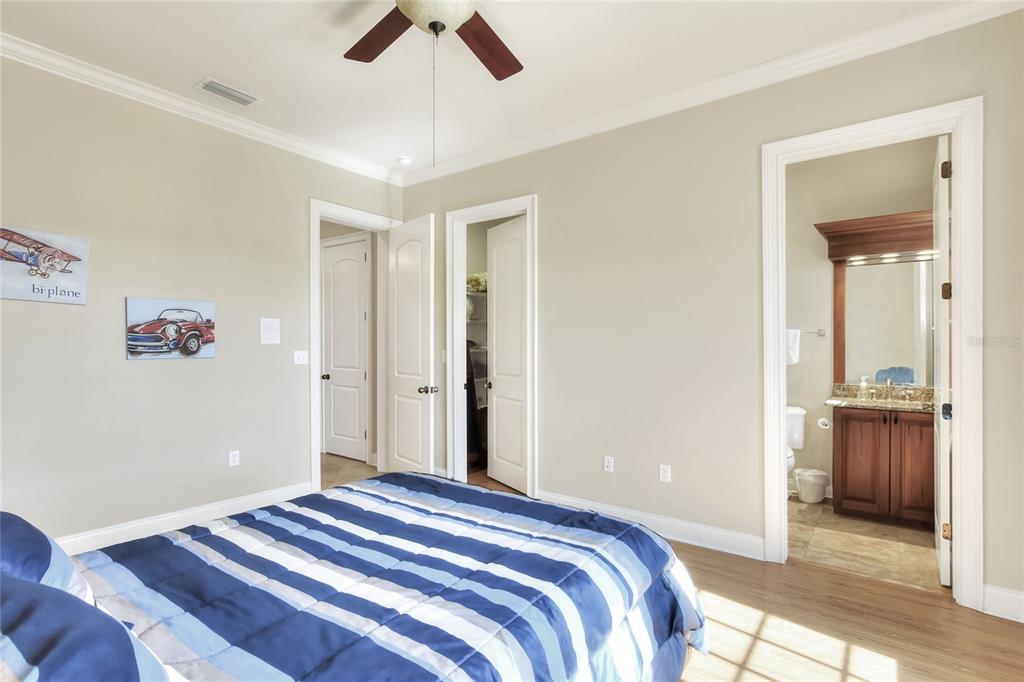 4215 Sb Merrion Road Lakeland, FL 33810 - Photo 72 of 95 a bedroom with a bed and a chandelier fan