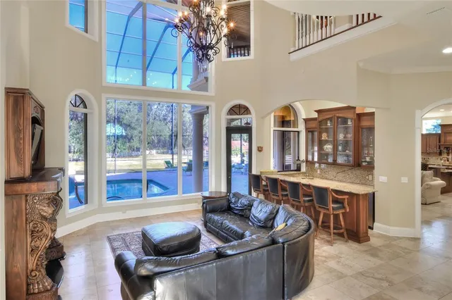 a kitchen with kitchen island granite countertop wooden cabinets a sink dishwasher stove and refrigerator with wooden floor