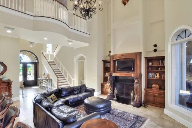a dining room with furniture a chandelier and wooden floor