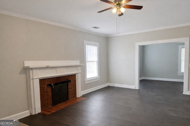 405 South Leroy Street Metter, GA 30439 - Photo 2 of 25 a view of an empty room with window and fireplace