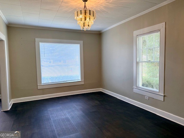 405 South Leroy Street Metter, GA 30439 - Photo 5 of 25 en empty room with wooden floor chandelier and windows