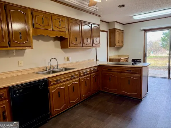 a kitchen with stainless steel appliances granite countertop a sink a stove and cabinets