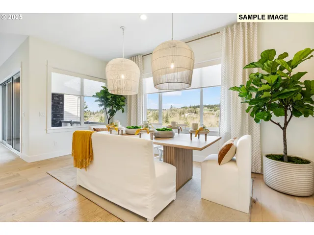 a living room with kitchen island furniture and a potted plant
