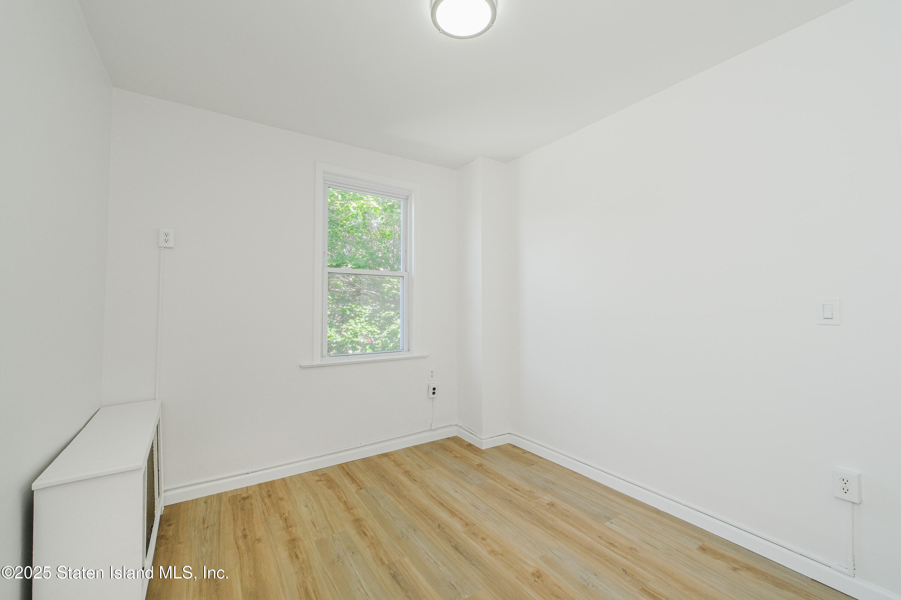 435 Castleton Avenue Staten Island, NY 10301 - Photo 13 of 47 an empty room with a window