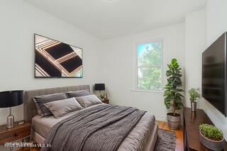 435 Castleton Avenue Staten Island, NY 10301 - Photo 16 of 47 a bedroom with a bed and a potted plant