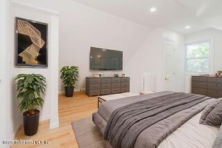 435 Castleton Avenue Staten Island, NY 10301 - Photo 17 of 47 a bedroom with a bed and a potted plant