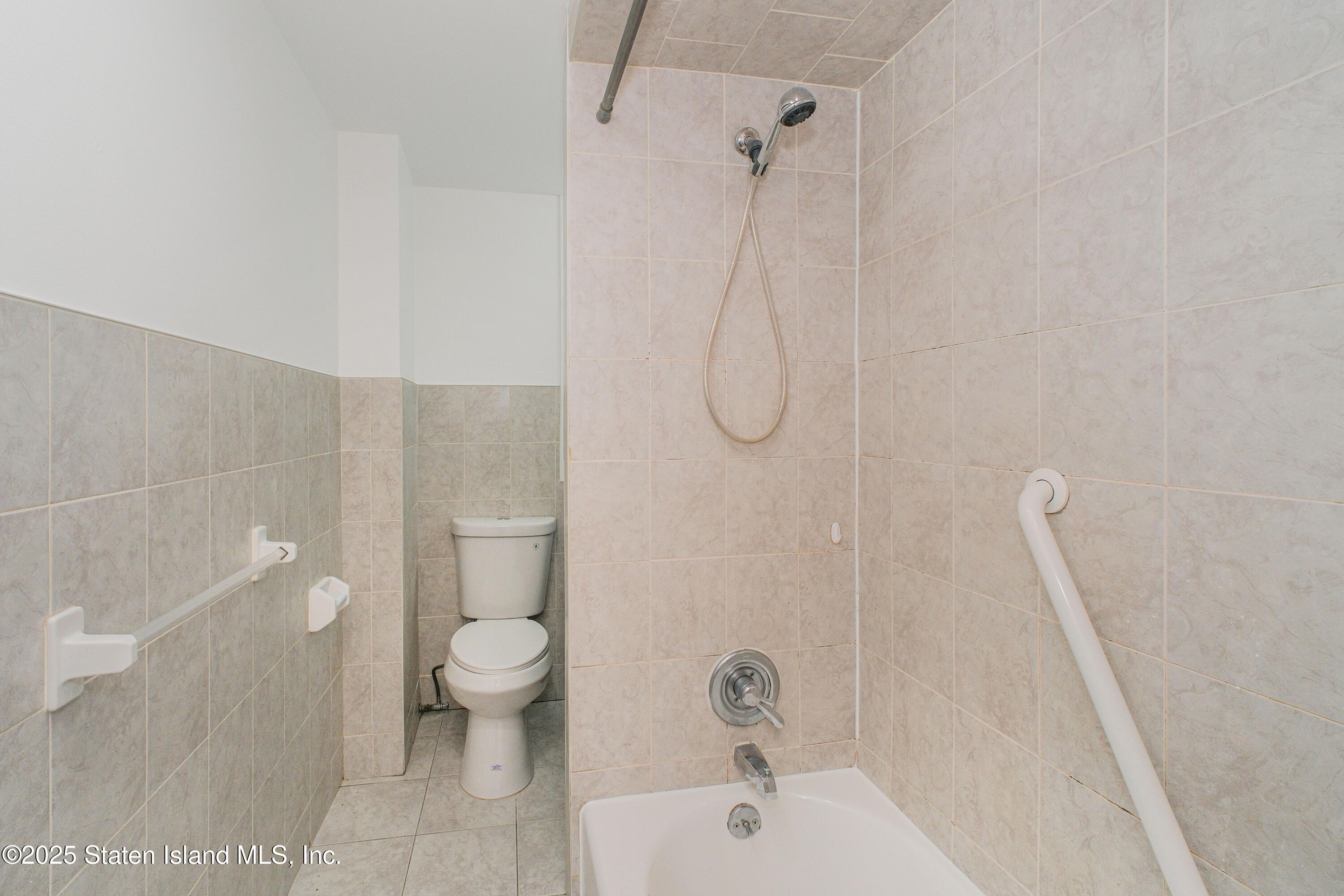 435 Castleton Avenue Staten Island, NY 10301 - Photo 19 of 47 a bathroom with a sink a toilet and shower