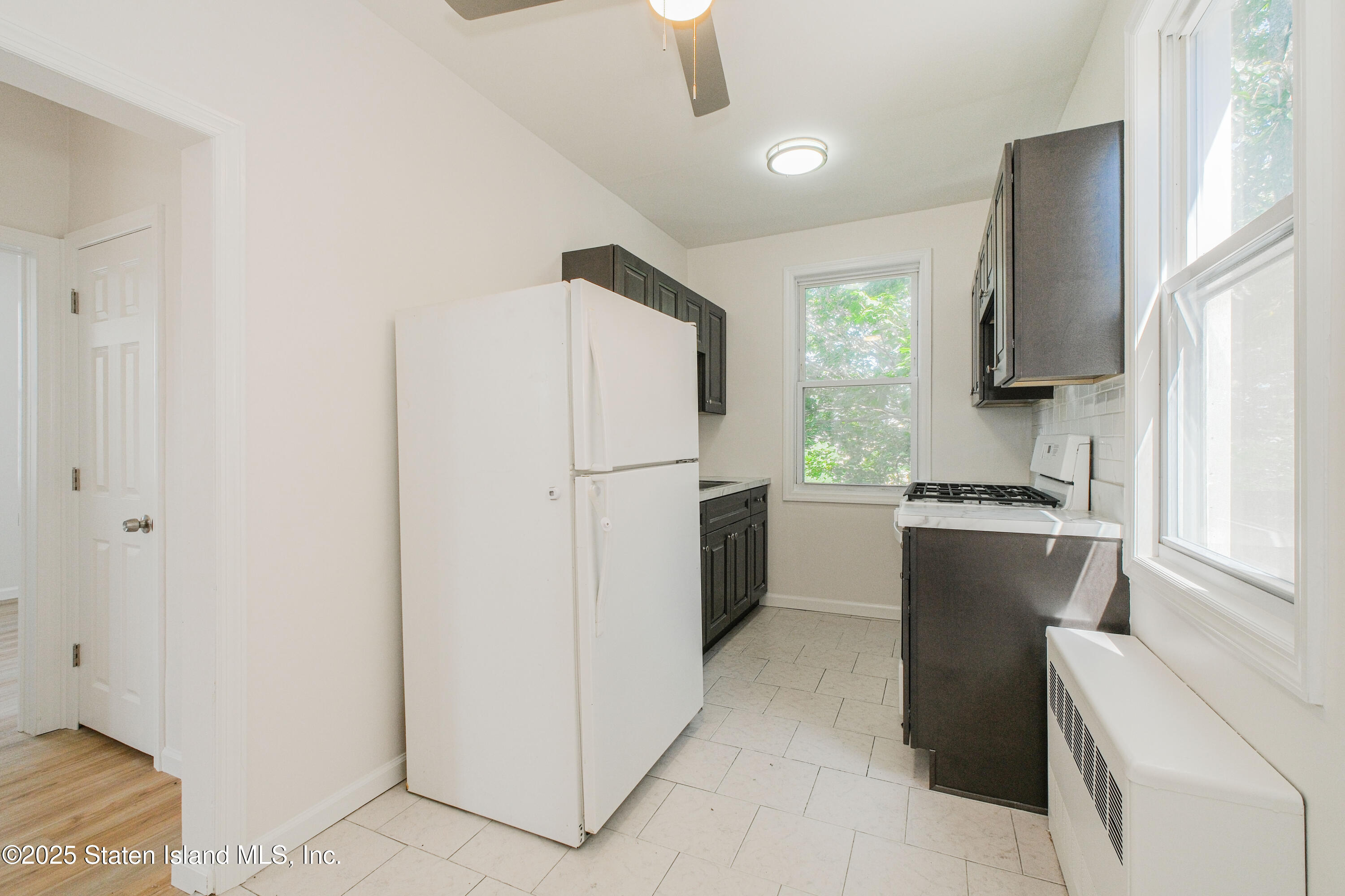 435 Castleton Avenue Staten Island, NY 10301 - Photo 20 of 47 a kitchen with a refrigerator sink and stove