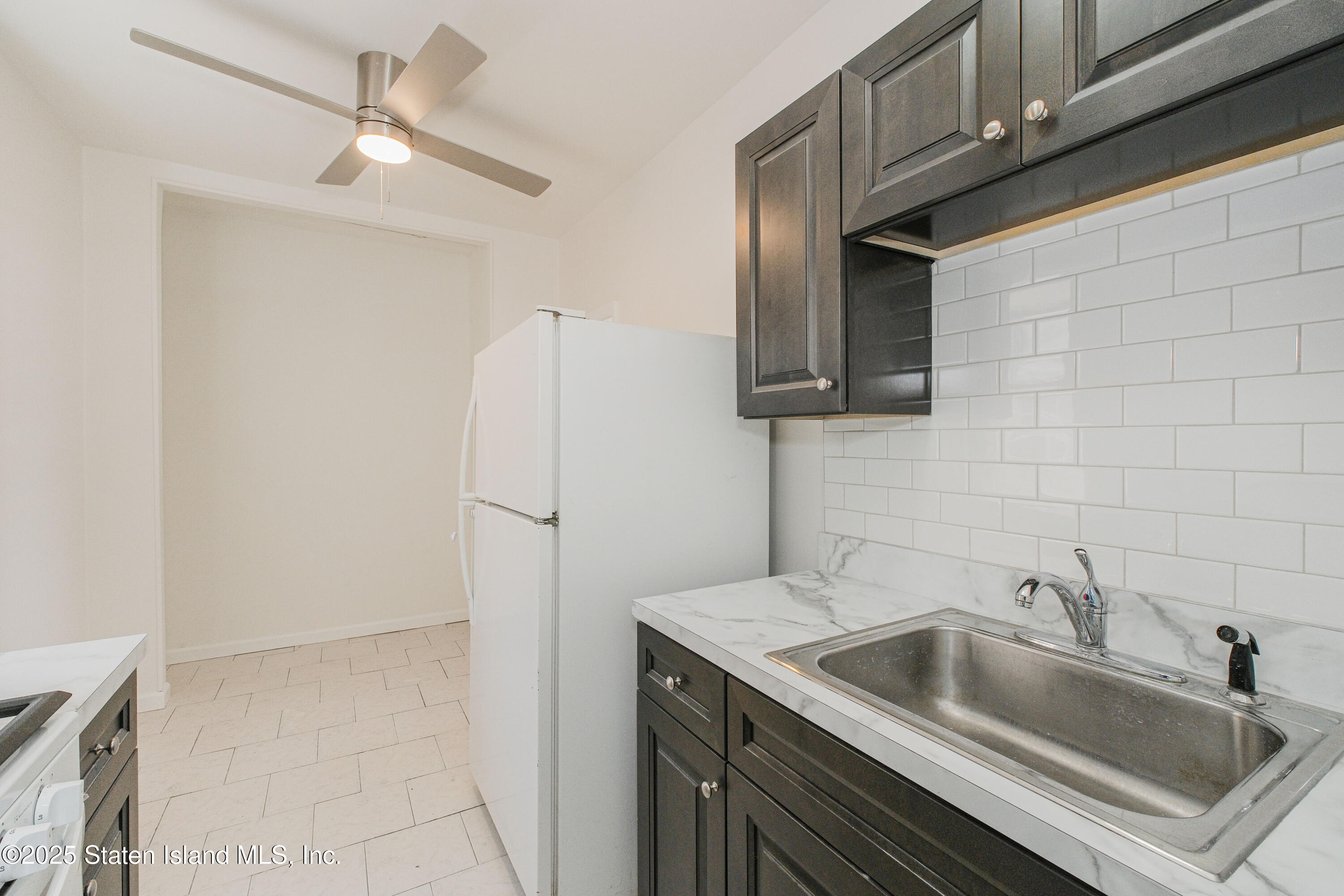435 Castleton Avenue Staten Island, NY 10301 - Photo 22 of 47 a kitchen with stainless steel appliances granite countertop a sink and a refrigerator