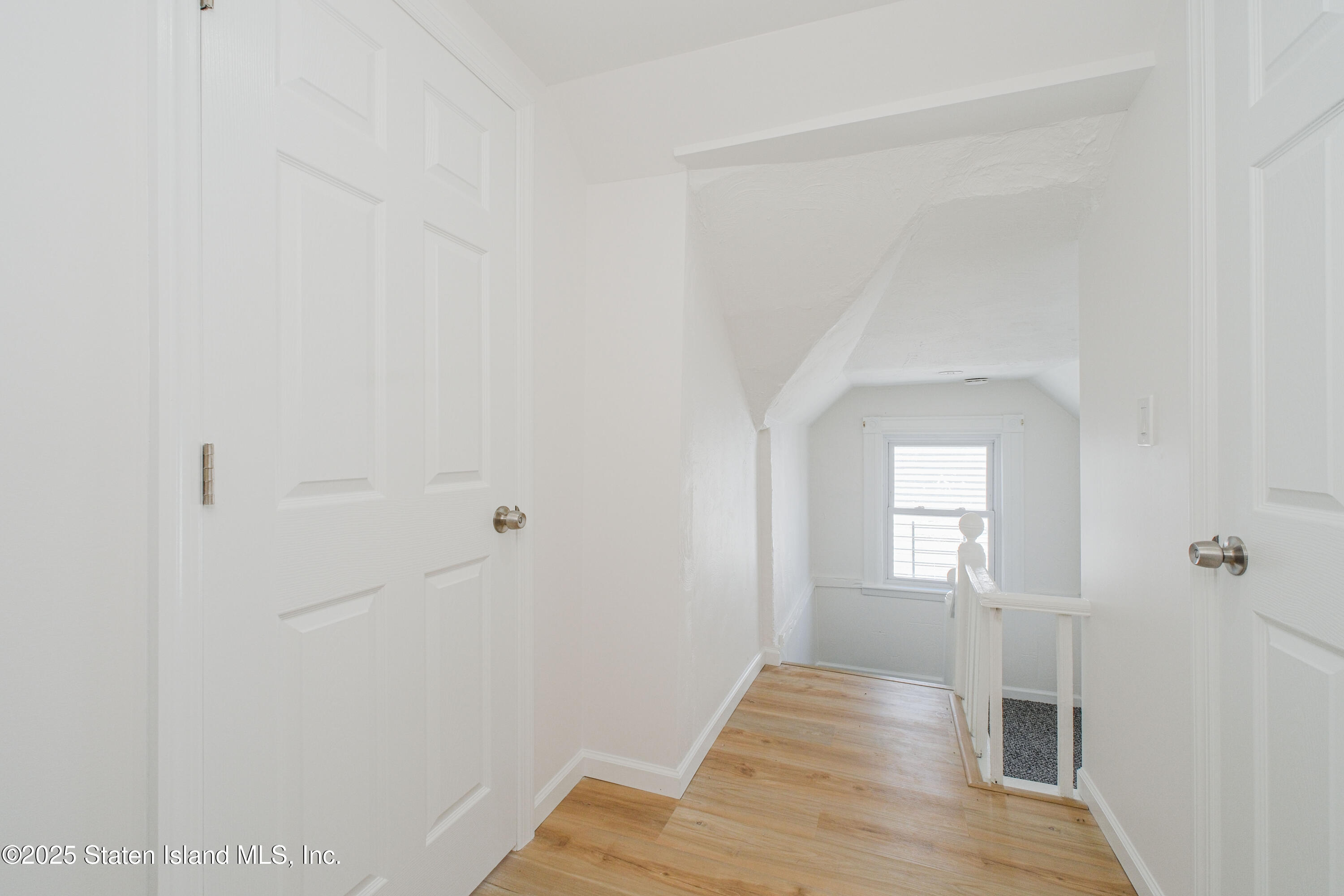 435 Castleton Avenue Staten Island, NY 10301 - Photo 29 of 47 a view of a room with wooden floor and windows