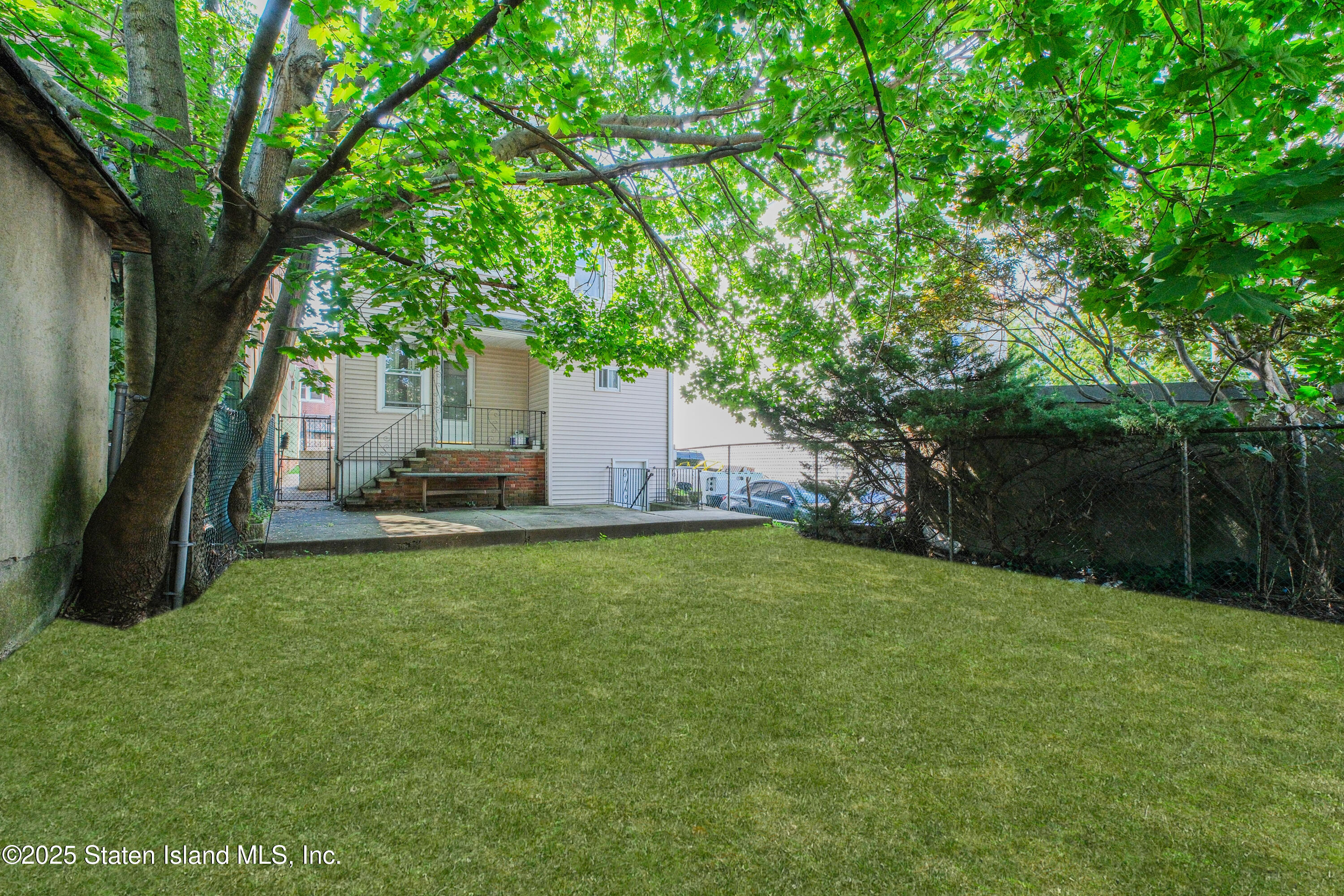 435 Castleton Avenue Staten Island, NY 10301 - Photo 3 of 47 a view of a tree in front of a white house