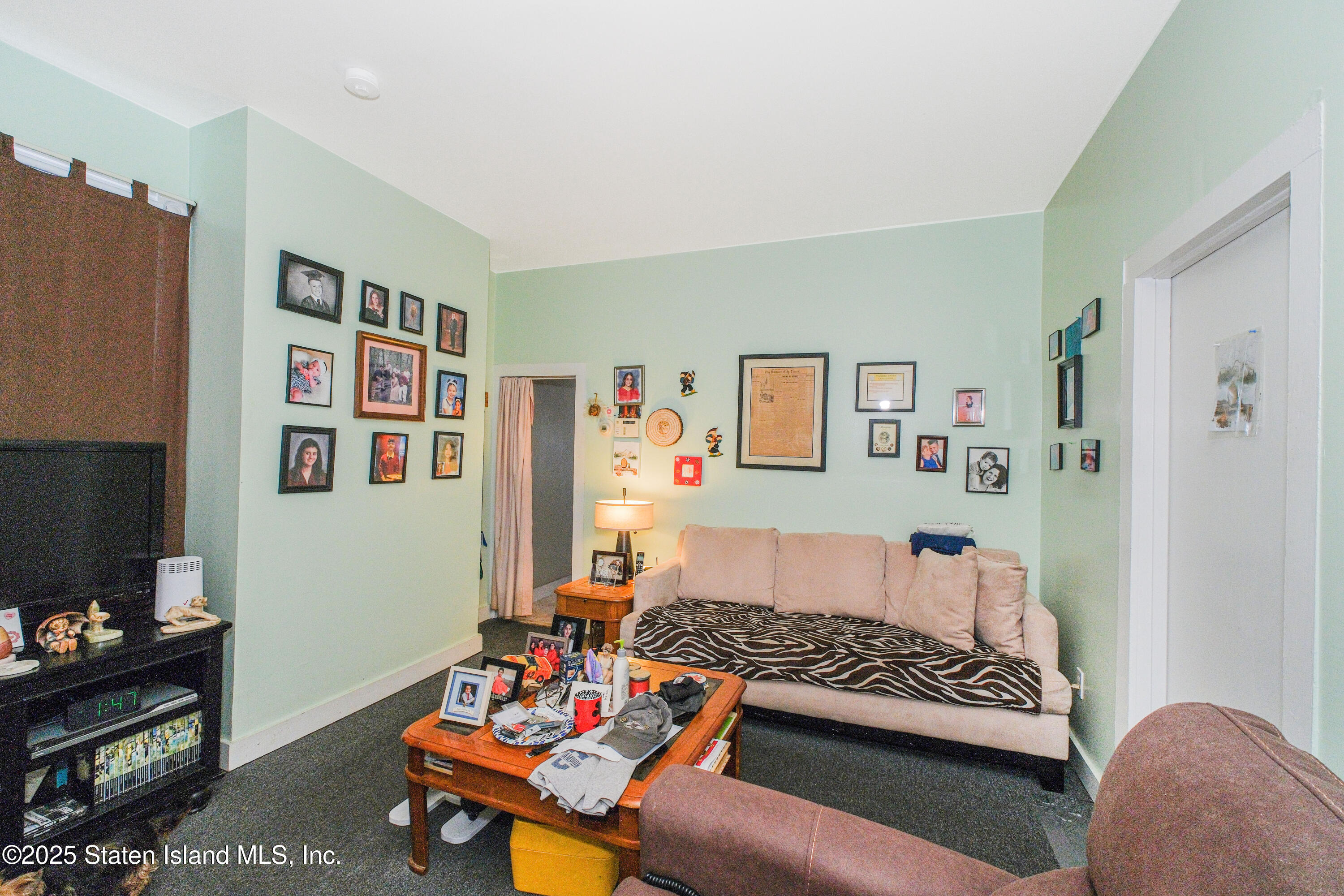 435 Castleton Avenue Staten Island, NY 10301 - Photo 32 of 47 a living room with furniture and a couch