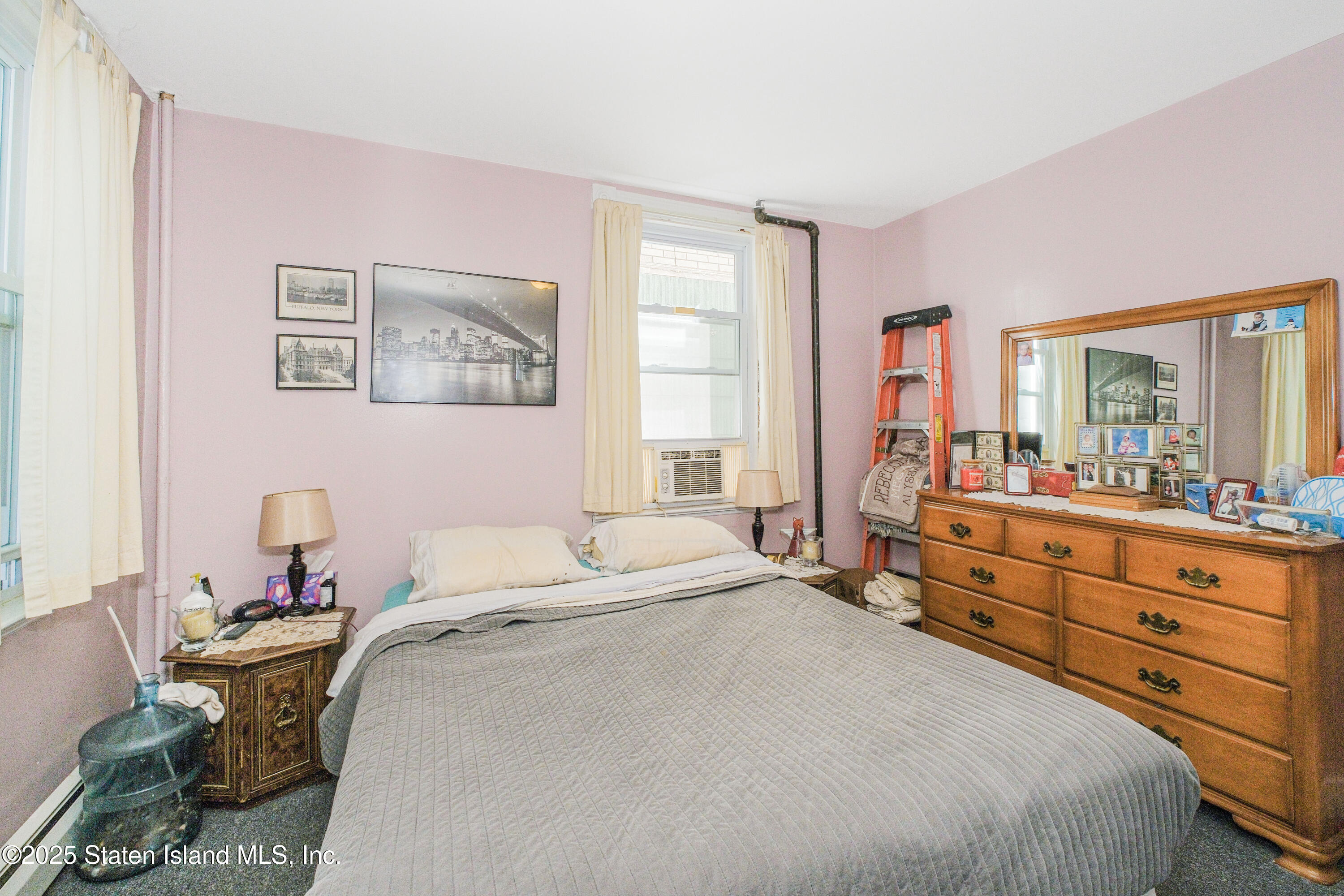 435 Castleton Avenue Staten Island, NY 10301 - Photo 35 of 47 a bedroom with a bed and a dresser