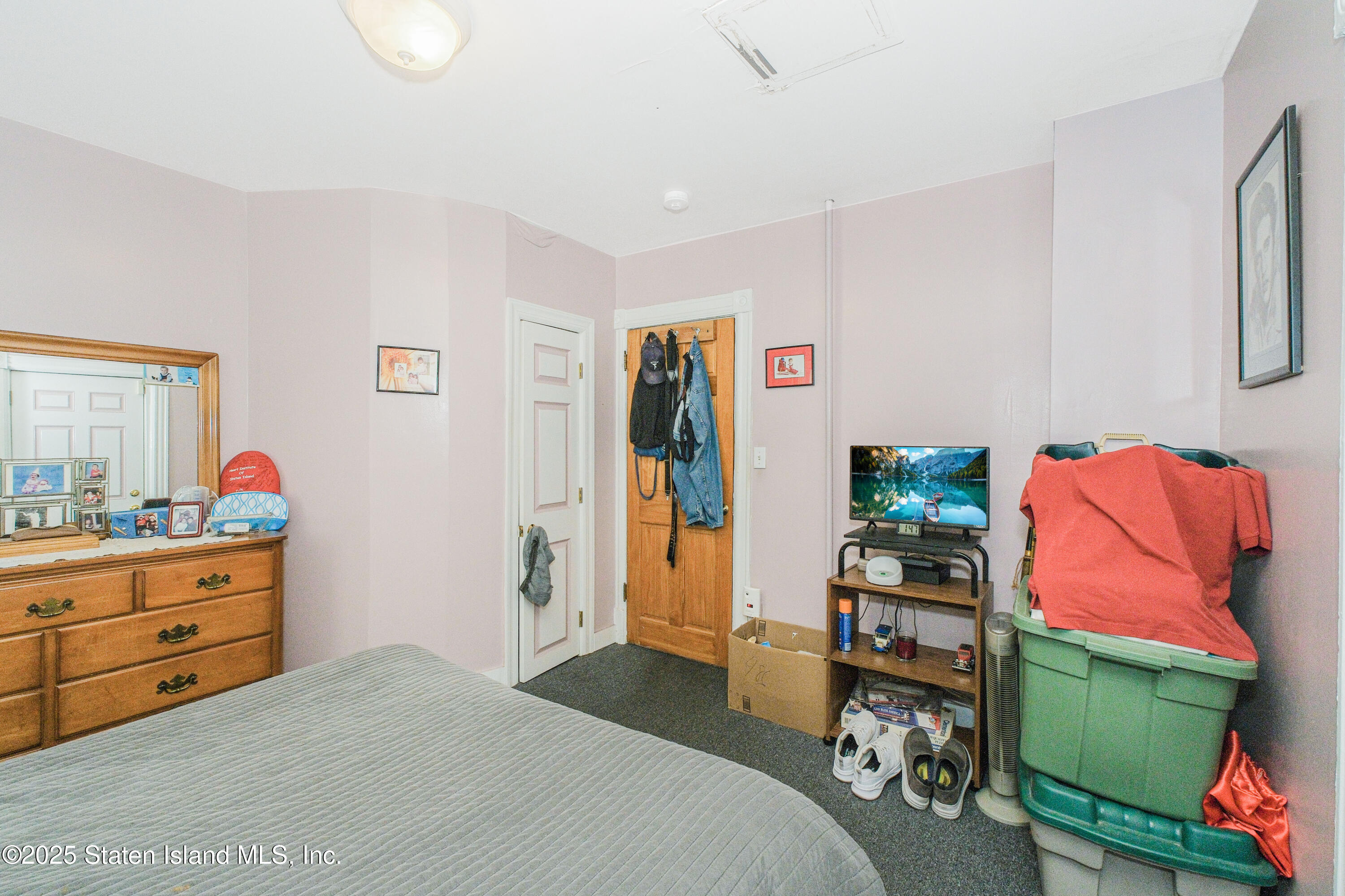 435 Castleton Avenue Staten Island, NY 10301 - Photo 36 of 47 a bedroom with a bed and a workspace