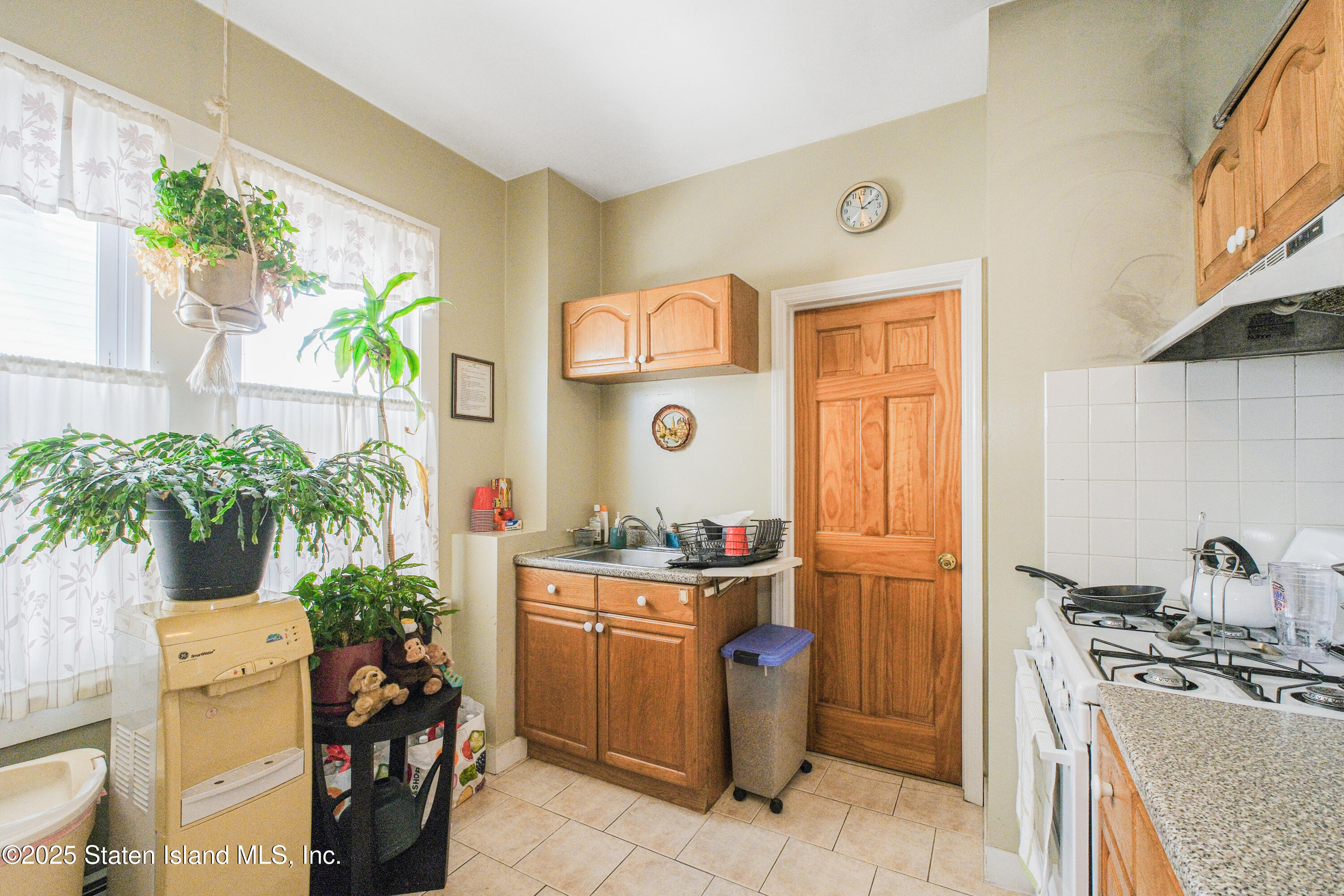 435 Castleton Avenue Staten Island, NY 10301 - Photo 39 of 47 a kitchen with a sink stove and refrigerator