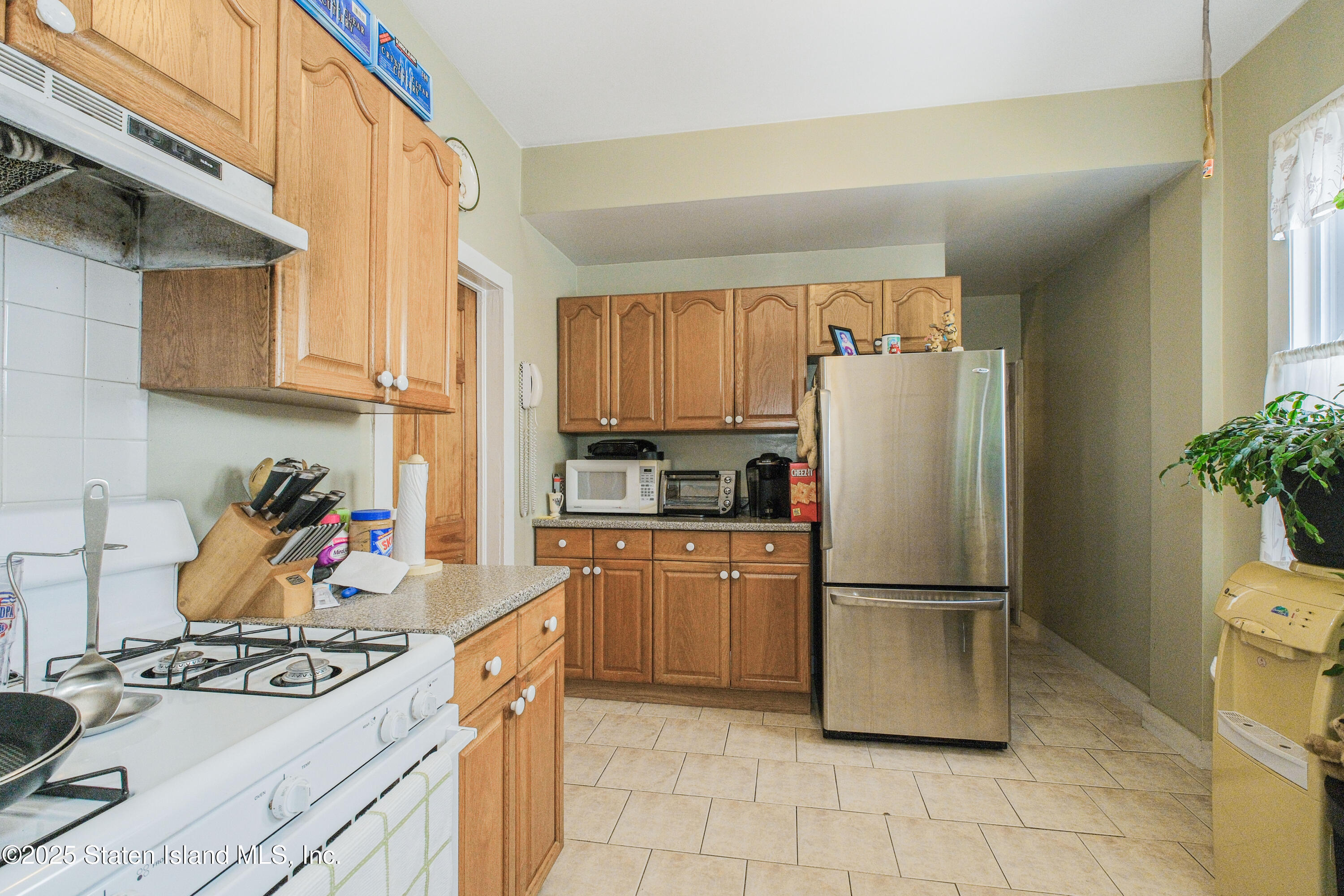 435 Castleton Avenue Staten Island, NY 10301 - Photo 40 of 47 a kitchen with stainless steel appliances granite countertop a refrigerator and a stove