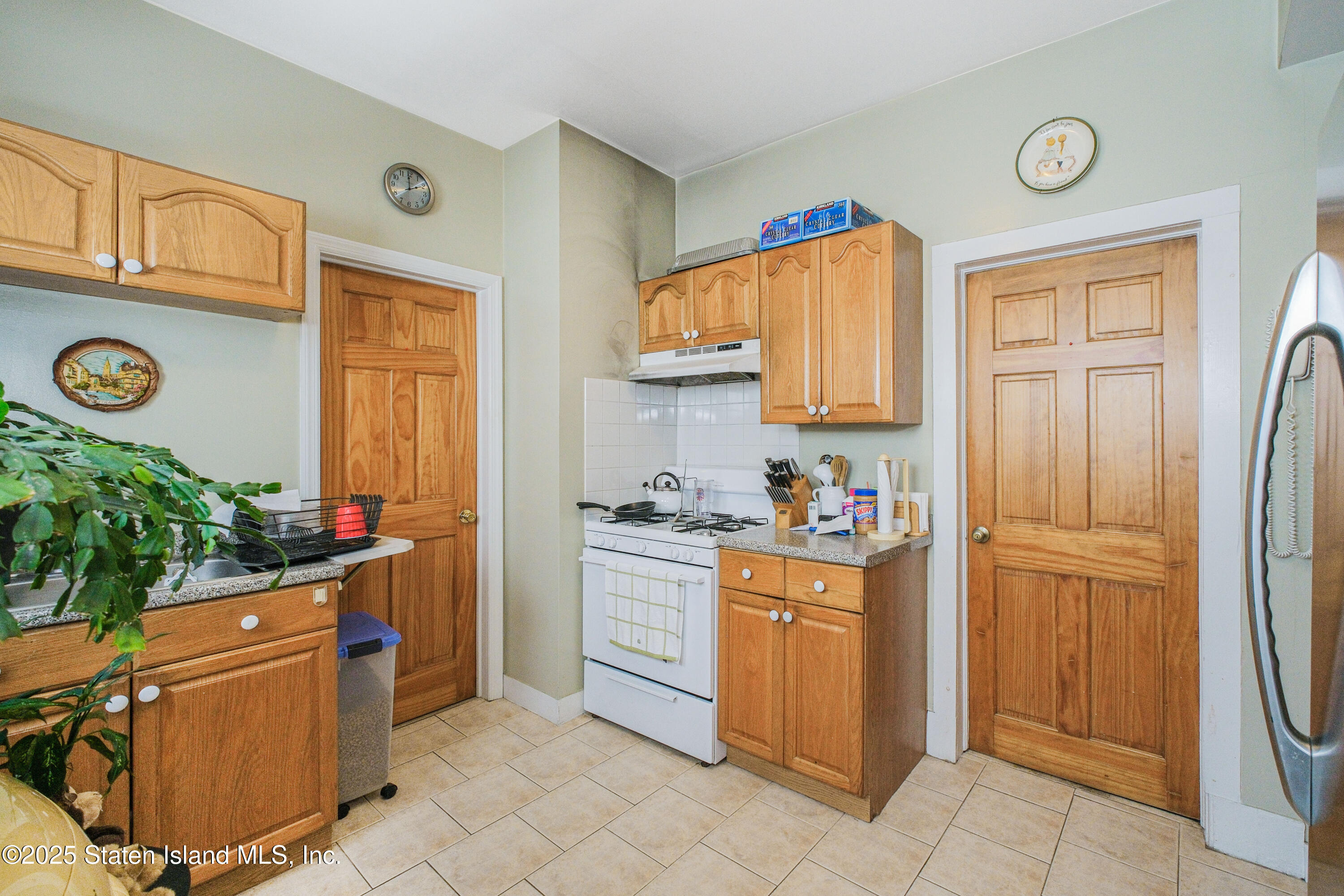 435 Castleton Avenue Staten Island, NY 10301 - Photo 41 of 47 a kitchen with stainless steel appliances granite countertop a refrigerator and a stove