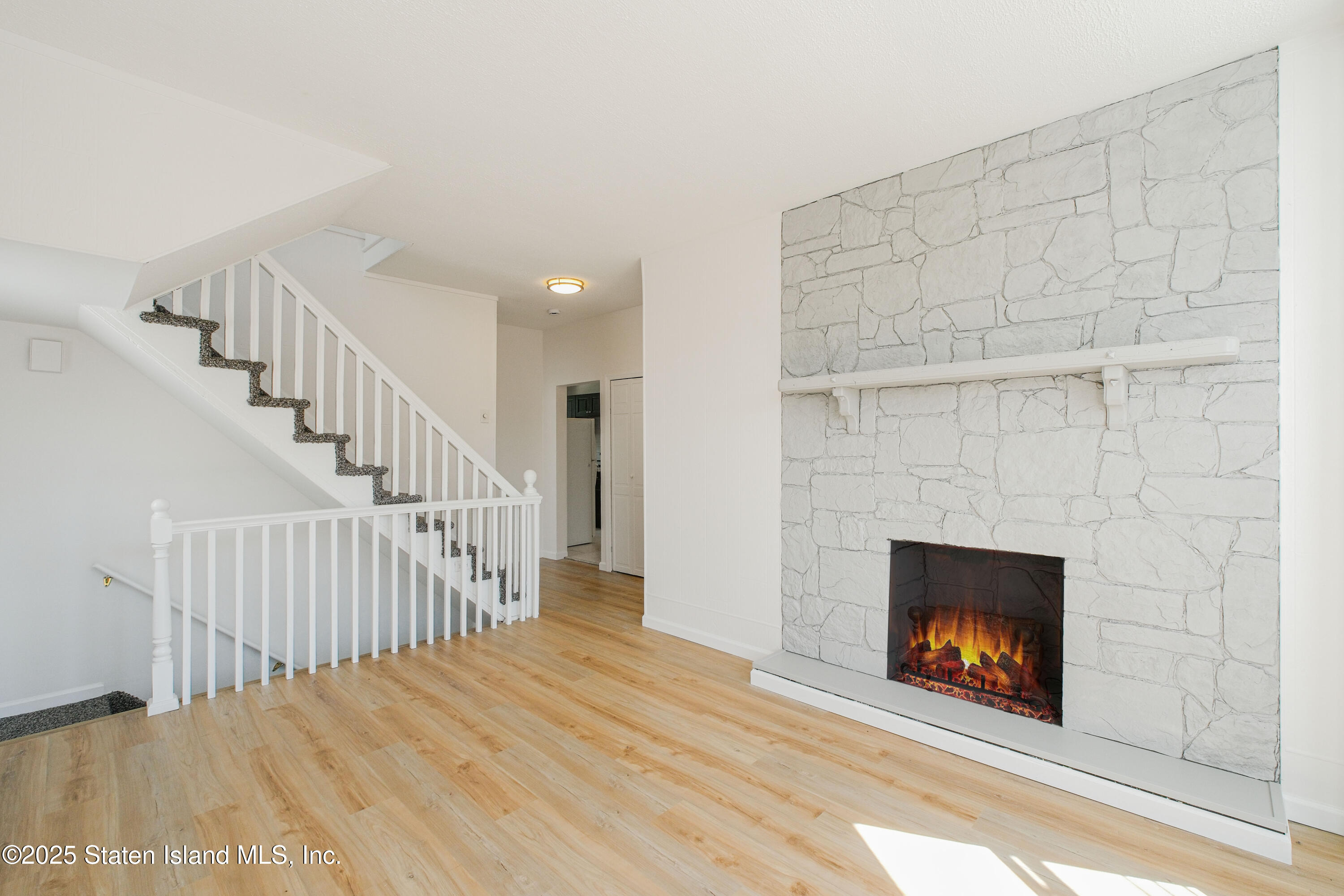 435 Castleton Avenue Staten Island, NY 10301 - Photo 6 of 47 a view of empty room with fireplace and wooden floor