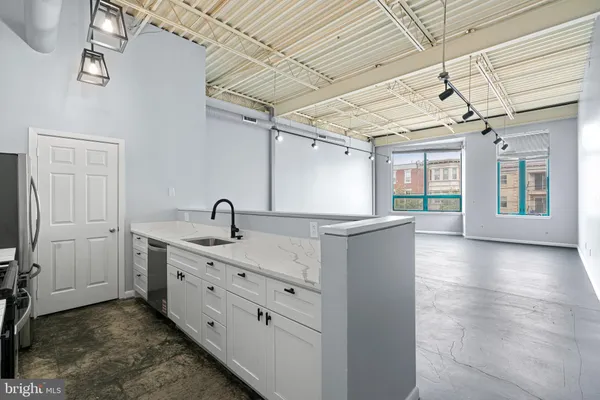 a view of a bathroom with a sink and mirror