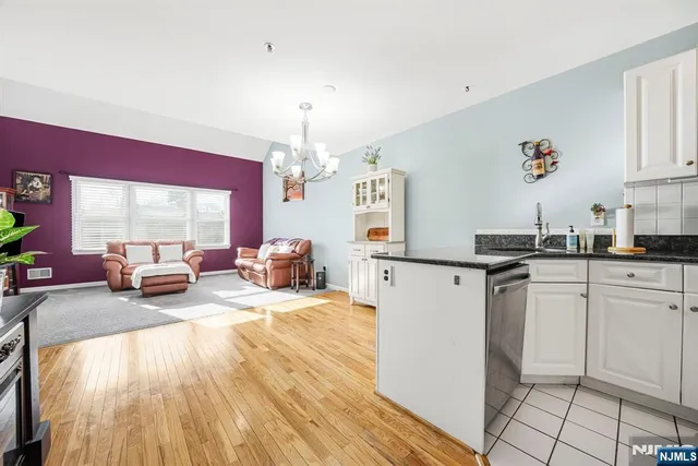 a living room with kitchen island granite countertop furniture and a fireplace