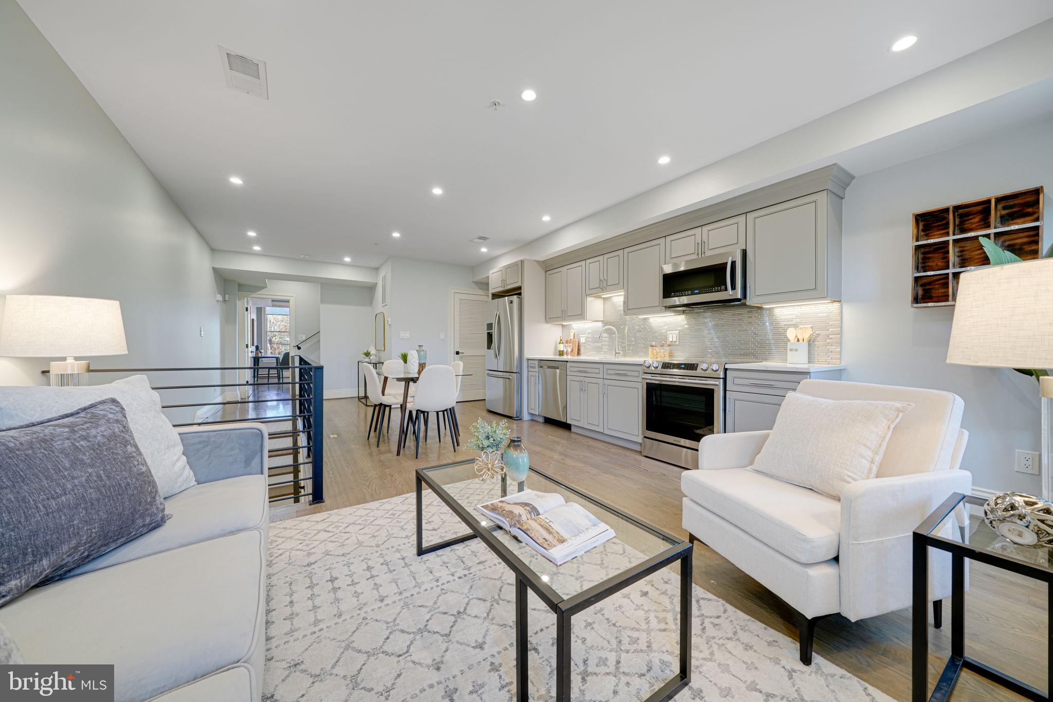 1728 D Street Southeast, Unit 2 Washington, DC 20003 - Photo 8 of 54 a living room with furniture a fireplace and a flat screen tv