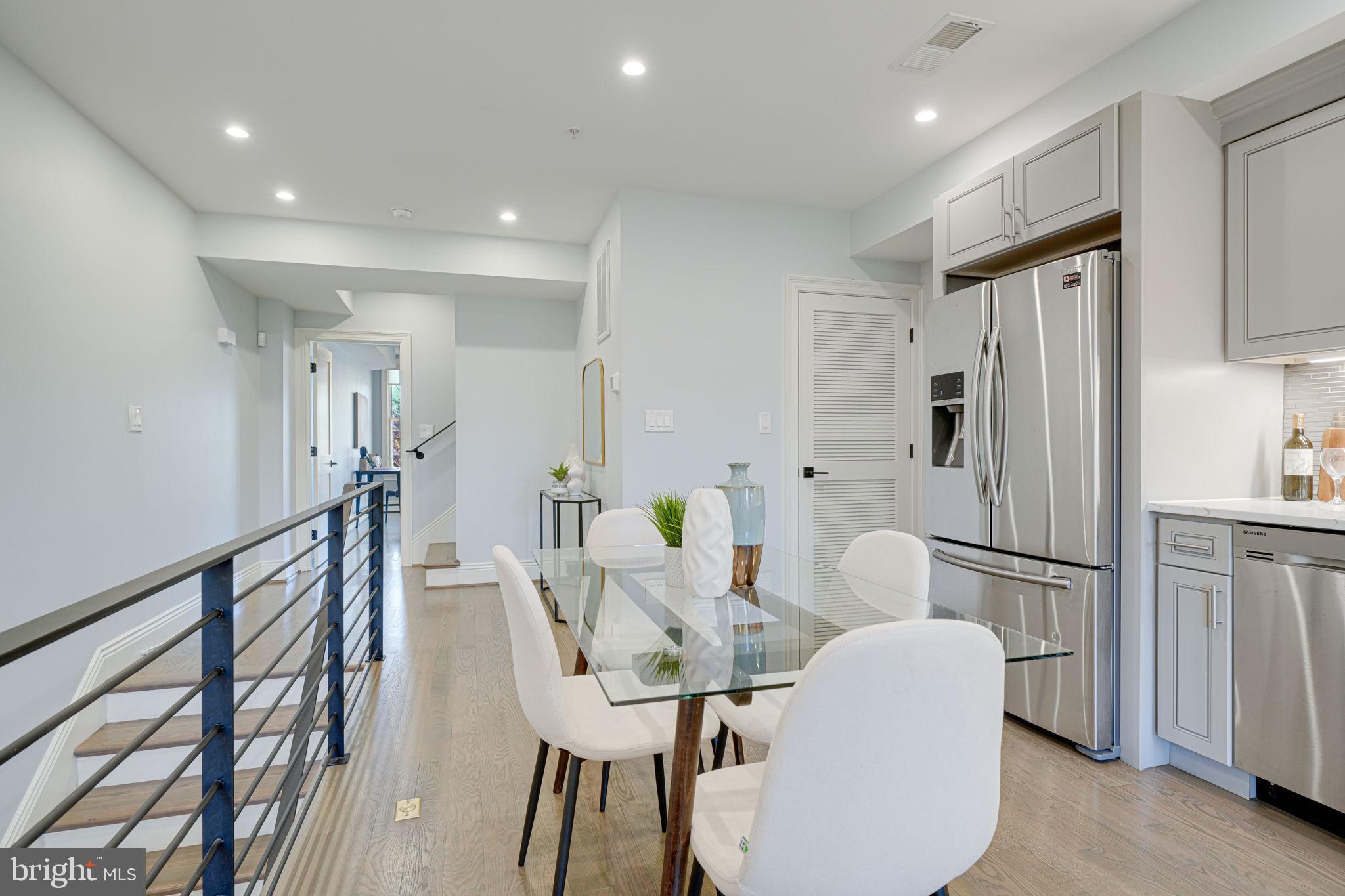 1728 D Street Southeast, Unit 2 Washington, DC 20003 - Photo 9 of 54 a dining room with furniture and a refrigerator