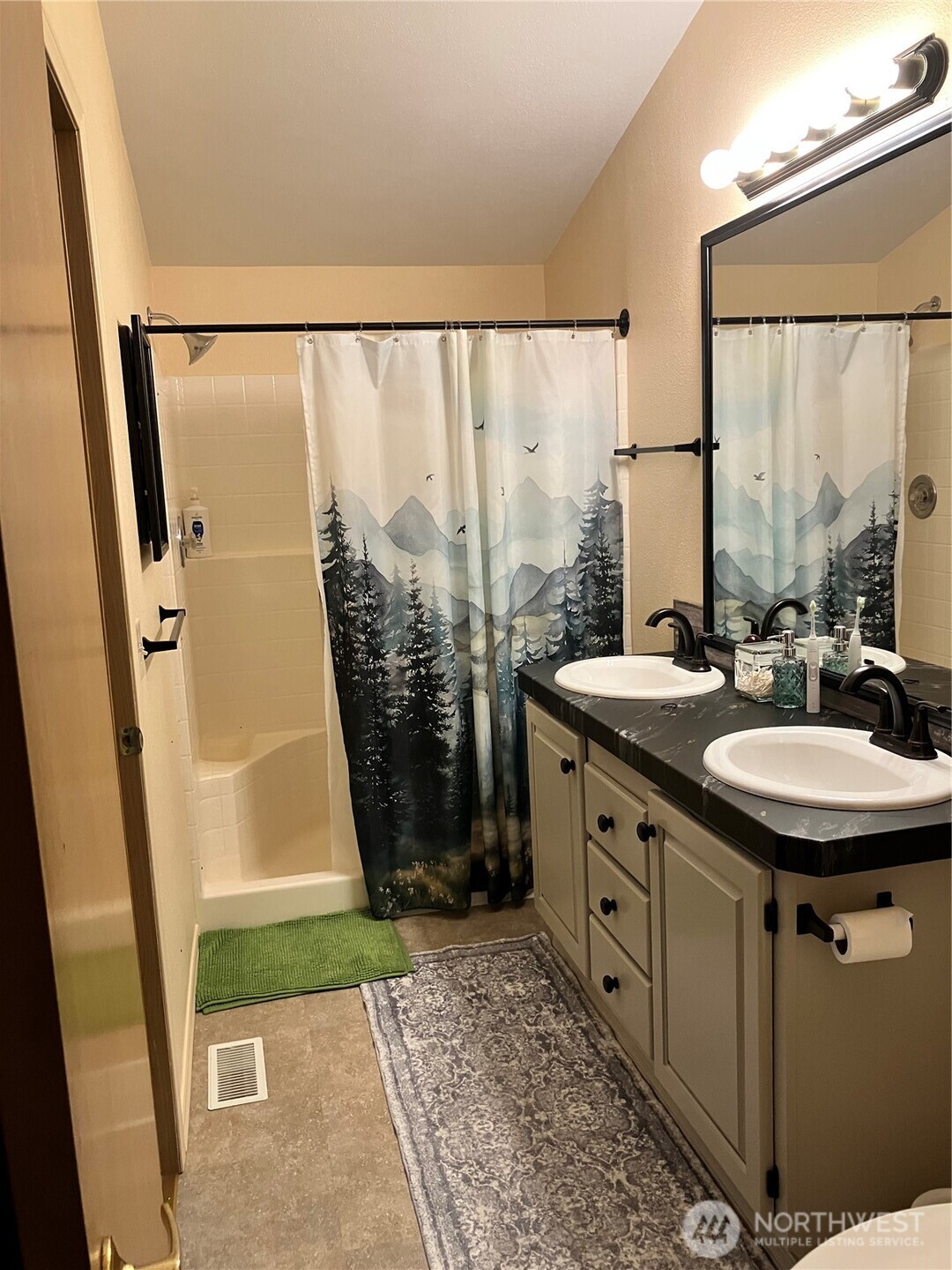 1171 Ray Hicks Street Raymond, WA 98577 - Photo 19 of 33 a bathroom with a granite countertop sink a mirror and a shower