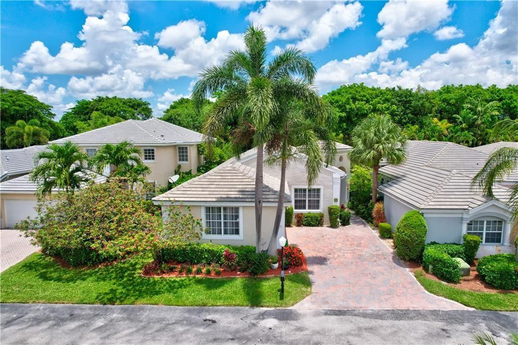 8171 Hampton Wood Drive Boca Raton, FL 33433 - Photo 33 of 56 a front view of a house with a garden