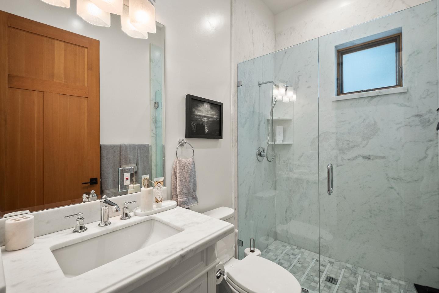 16362 Hilow Road Los Gatos, CA 95032 - Photo 21 of 55 a bathroom with a sink toilet a mirror and shower