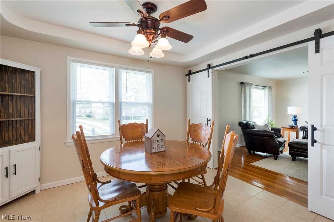 13175 McCracken Road Cleveland, OH 44125 - Photo 12 of 48 Eat-in kitchen dining area with light tile floors, a barn door, and a wealth of natural light