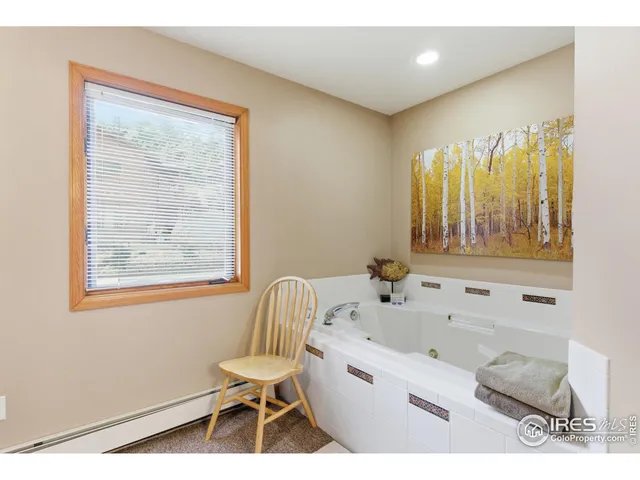 a bathroom with a bathtub and a window