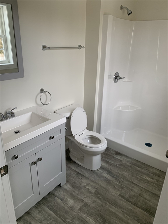 86 Beaumont Avenue Chicopee, MA 01013 - Photo 6 of 8 a bathroom with a toilet a sink a mirror and shower